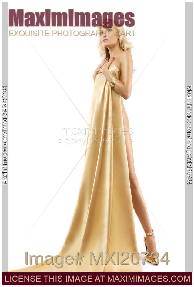 Beautiful nude blond woman covering with gold fabric