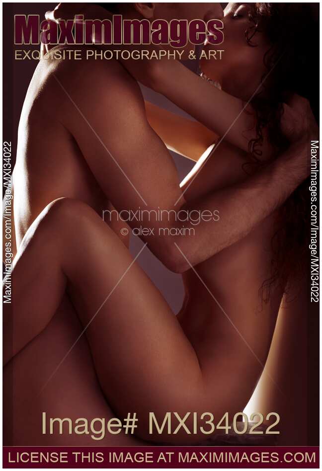 Beautiful nude couple making love in passionate embrace of their sensual bodies