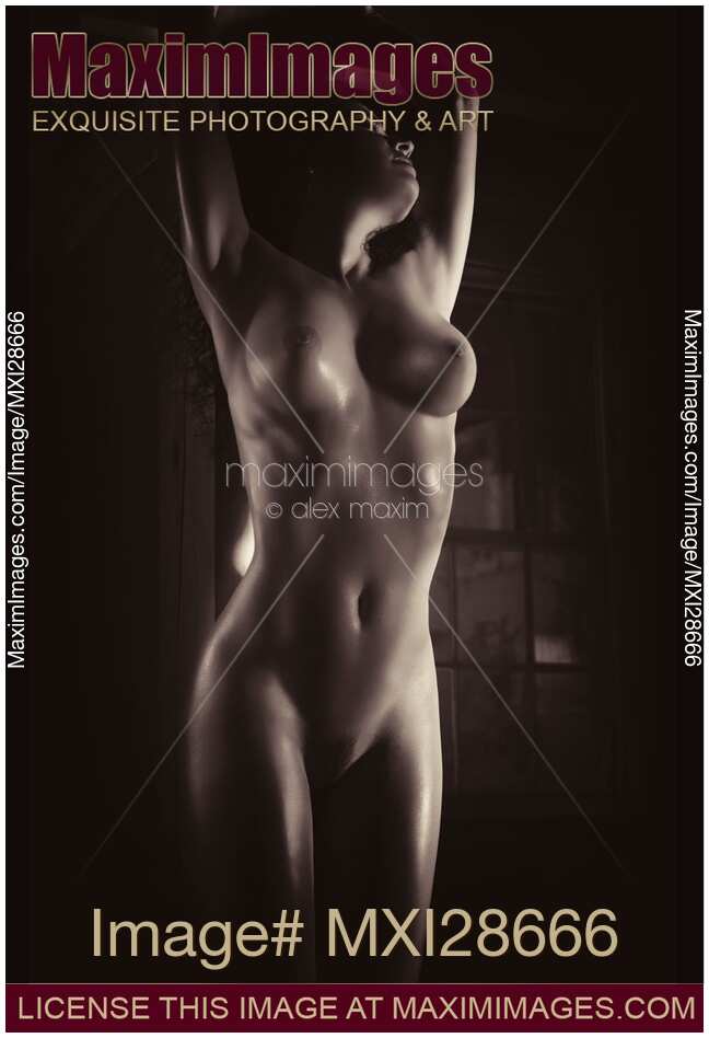 Beautiful nude woman body in dim dramatic light Black and white