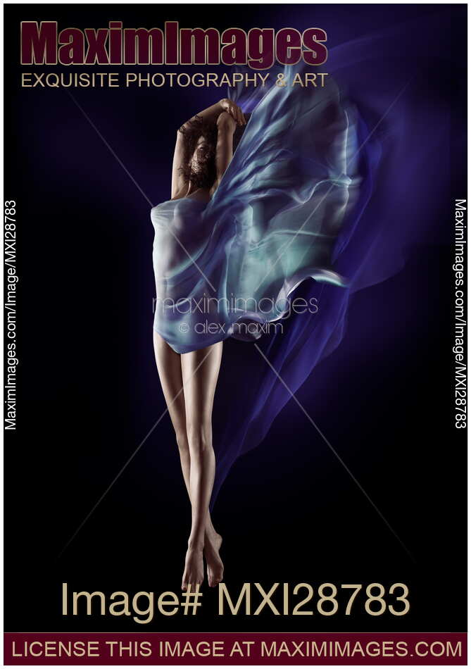 Beautiful nude woman floating in mid-air with flowing blue cloth wrapped around her body