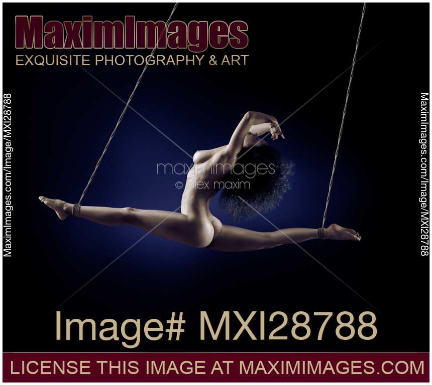 Beautiful nude woman flying suspended in splits by her ankles with bondage ropes