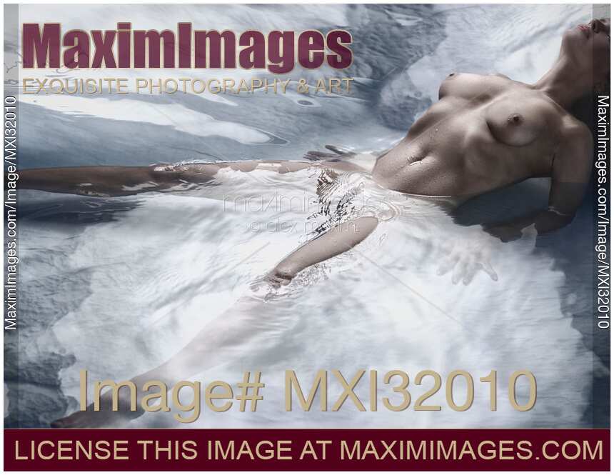 Beautiful nude woman lying in metallic water with her chest arching up and her legs apart