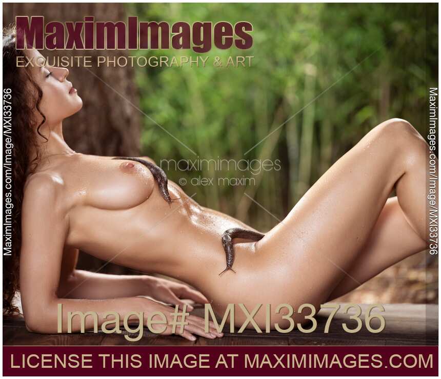 Beautiful nude woman lying in the nature with cute slimy slugs on her sexy wet naked body