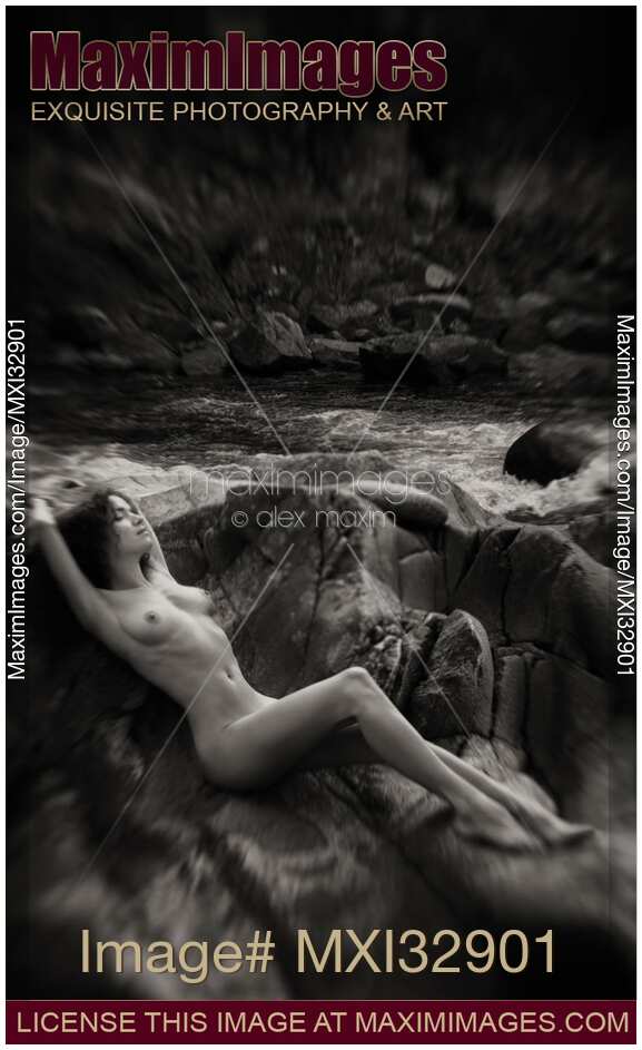 Beautiful nude woman lying on rocks by a river in nature scenery Black and white art nudes