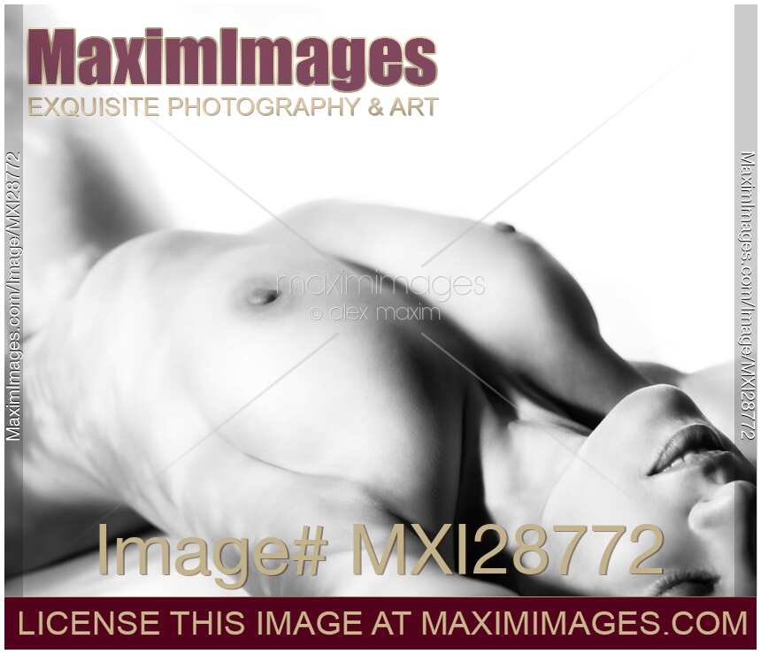 Beautiful nude woman with shadows of tree leaves on her body