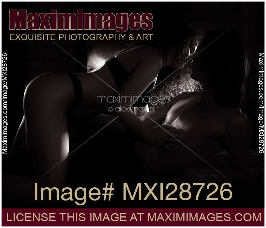 Beautiful sensual couple making love in front of fireplace Black and white