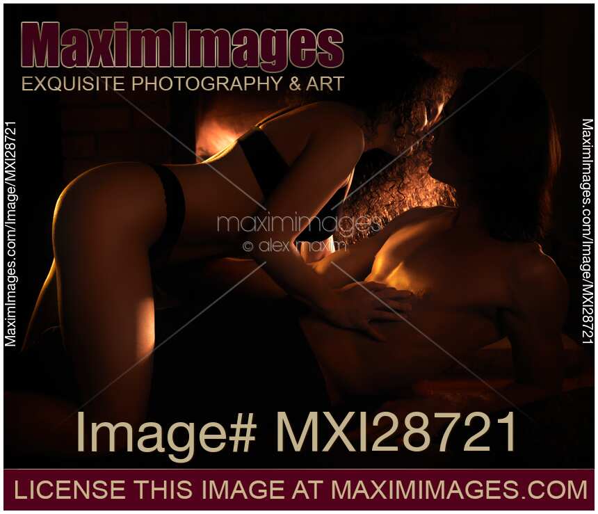 Beautiful sensual couple making love in front of fireplace