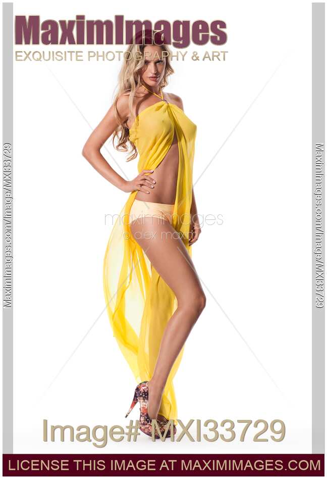 Beautiful sexy blond woman wearing bikini and yellow see-through beach wear cover