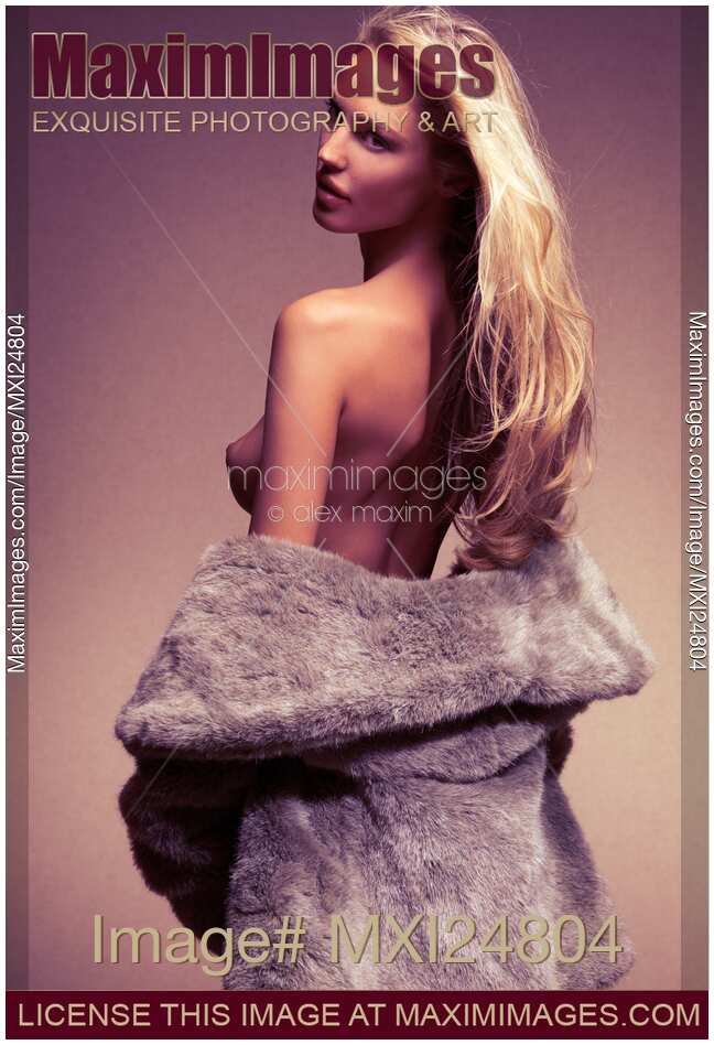 Beautiful sexy woman in fur coat over naked body