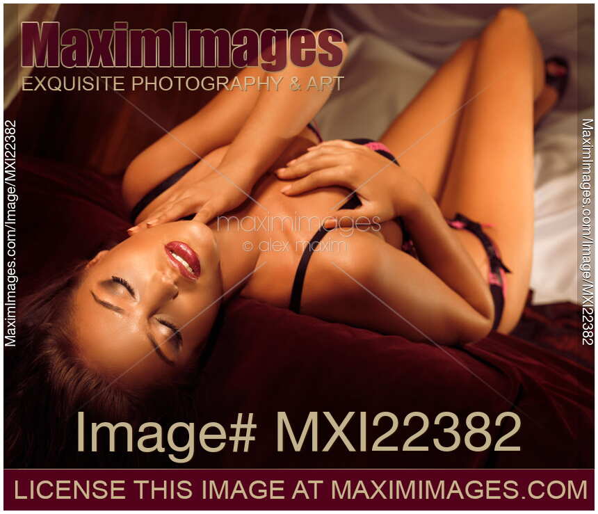 Beautiful Sexy Woman Lying on a Bed. Sensual glamour portrait.
