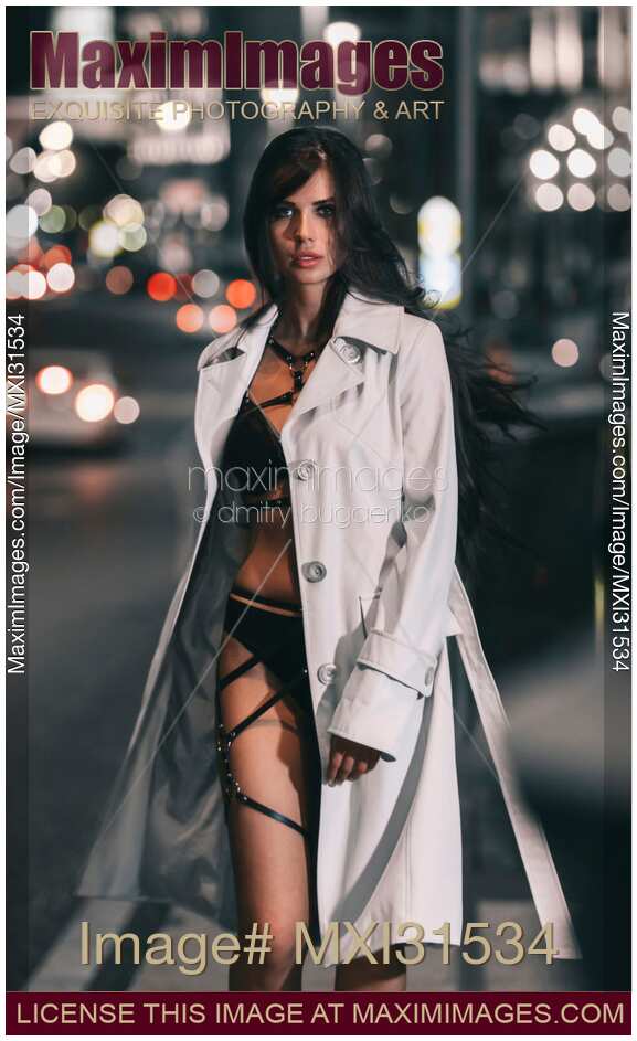 Beautiful sexy woman provocatively dressed walking on a city street