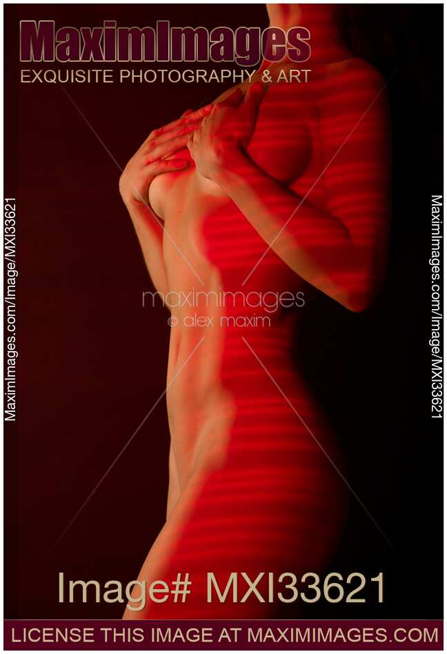 Beautiful slim nude woman body with red laser stripes on bare skin