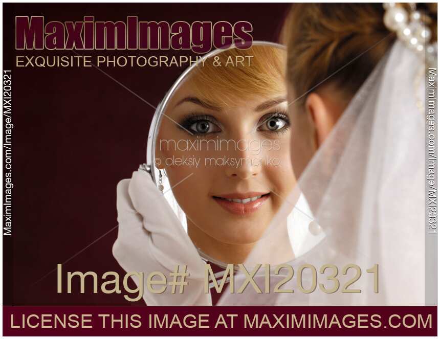 Beautiful Smiling Woman in Bridal Veil Looking in Mirror