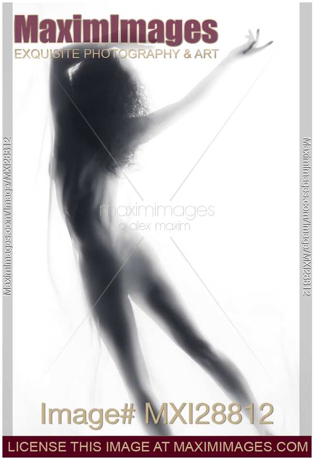 Beautiful surreal silhouette of a nude woman figure in glowing foggy light