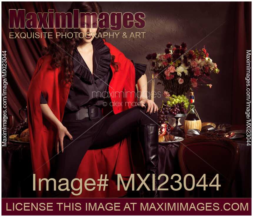 Beautiful Woman in Red Coat at a Festive Table