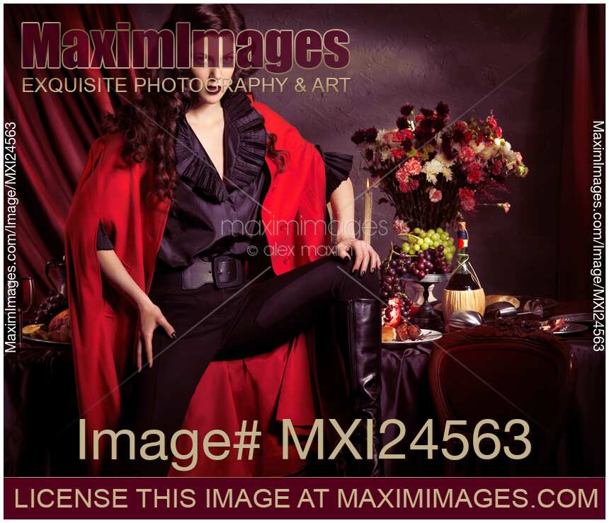 Beautiful woman in red coat in front of festive table