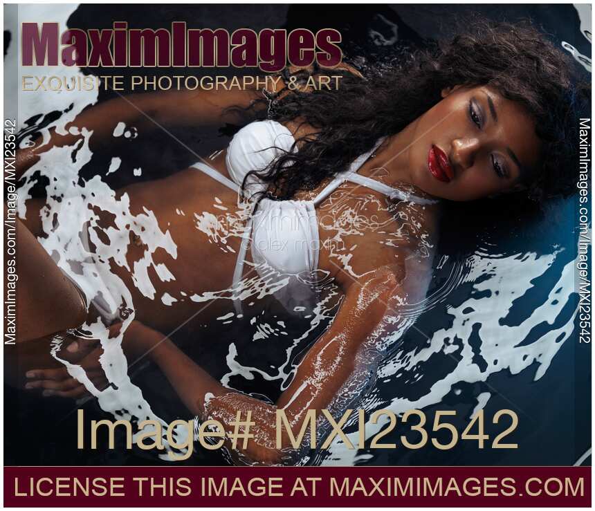 Beautiful Woman in Swimsuit Lying in Water