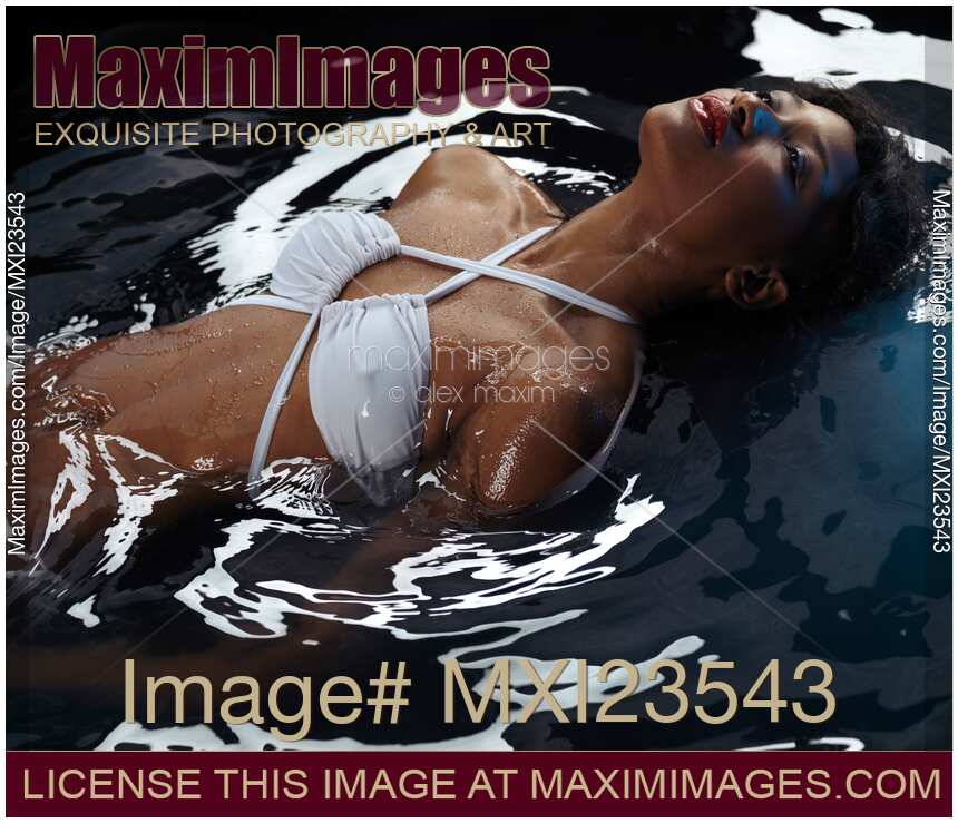 Beautiful Woman in Swimsuit Lying in Water
