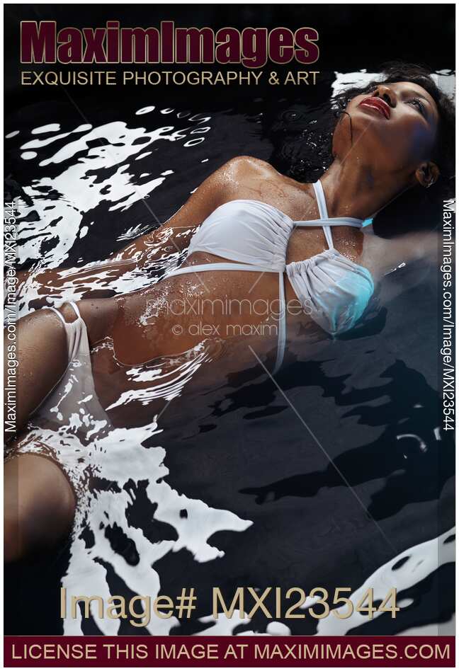 Beautiful Woman in Swimsuit Lying in Water