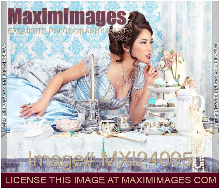 Beautiful woman lying on a tea party table