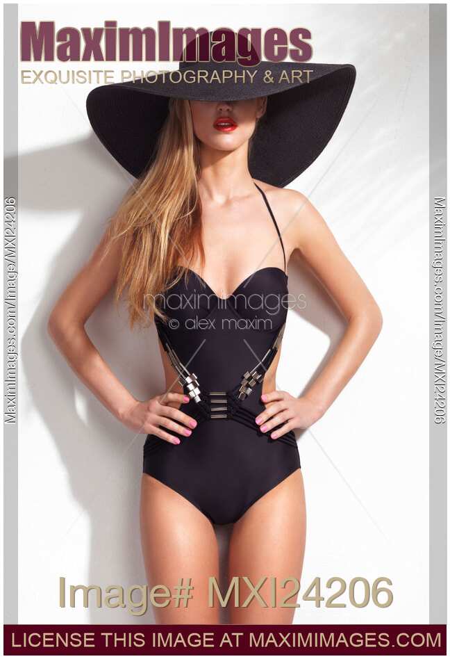 Beautiful woman wearing a trendy one-piece swimsuit and a sunhat