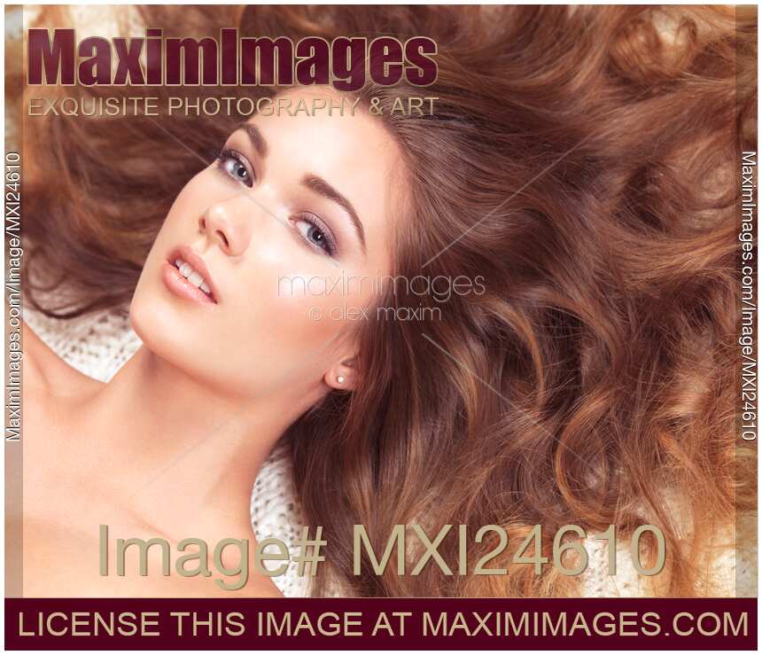 Beautiful woman with long hair spread around her