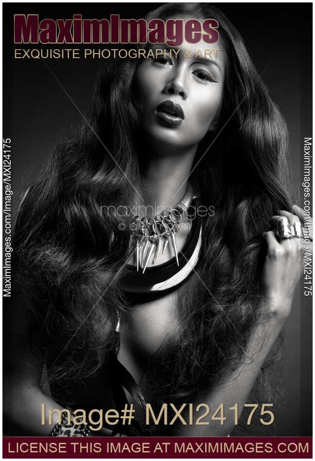 Beautiful woman with long hair wearing jewellery black and white