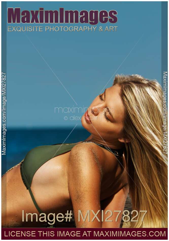 Beautiful young blond woman in bikini on the beach