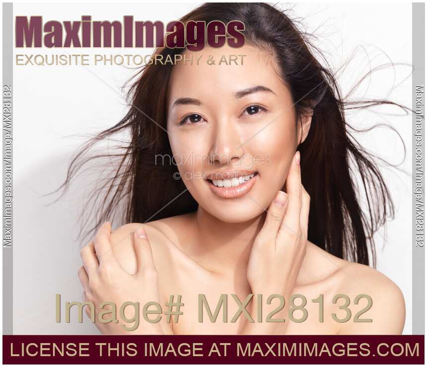 Beautiful young smiling asian woman with flying hair