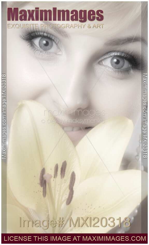 Beautiful Young Smiling Woman with Yellow Lily