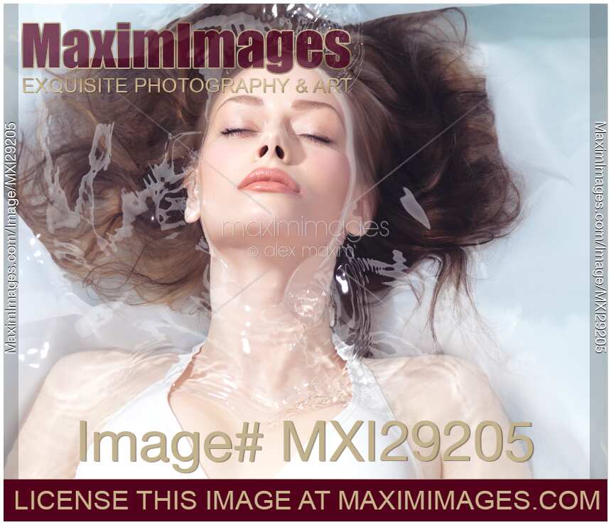 Beautiful young woman face and hair in clear water Beauty portrait