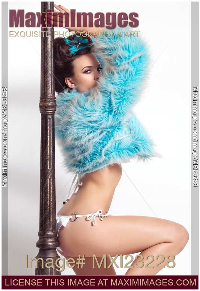 Beautiful Young Woman in Bikini and Fur Jacket