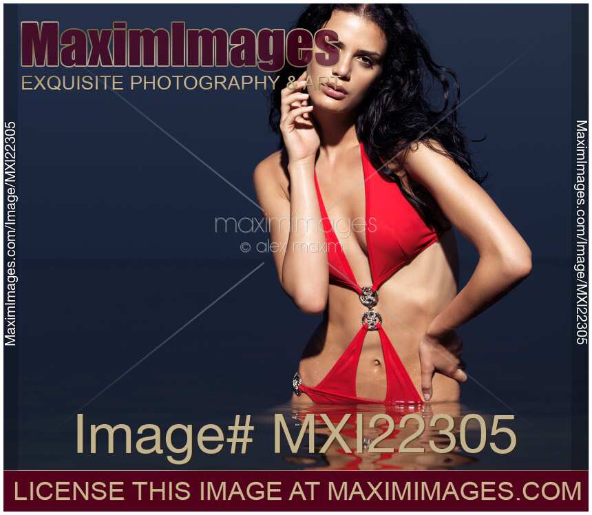 Beautiful Young Woman in Red Swimsuit Standing in Water