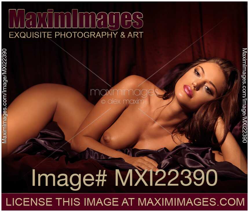 Beautiful Young Woman Lying Naked in Bed