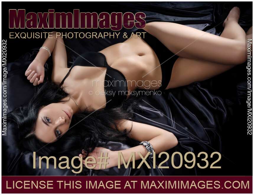 Beautiful Young Woman Lying on a Bed