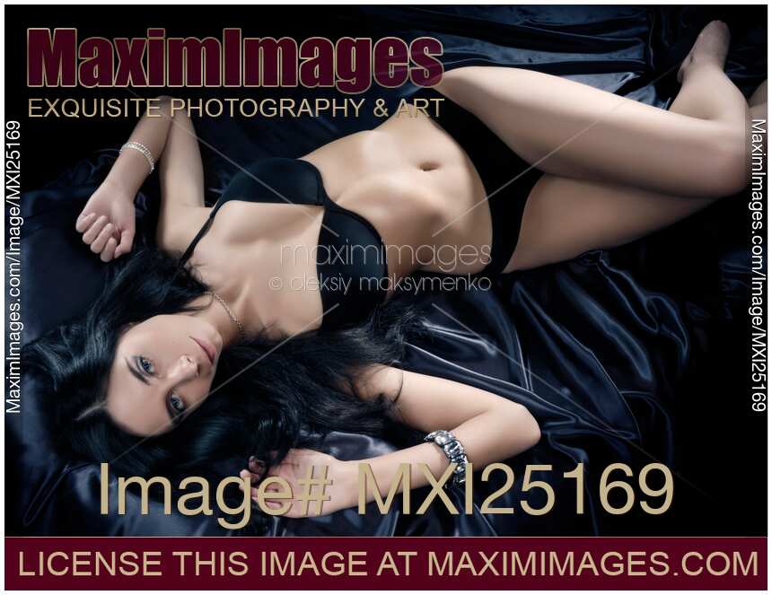 Beautiful Young Woman Lying on a Bed
