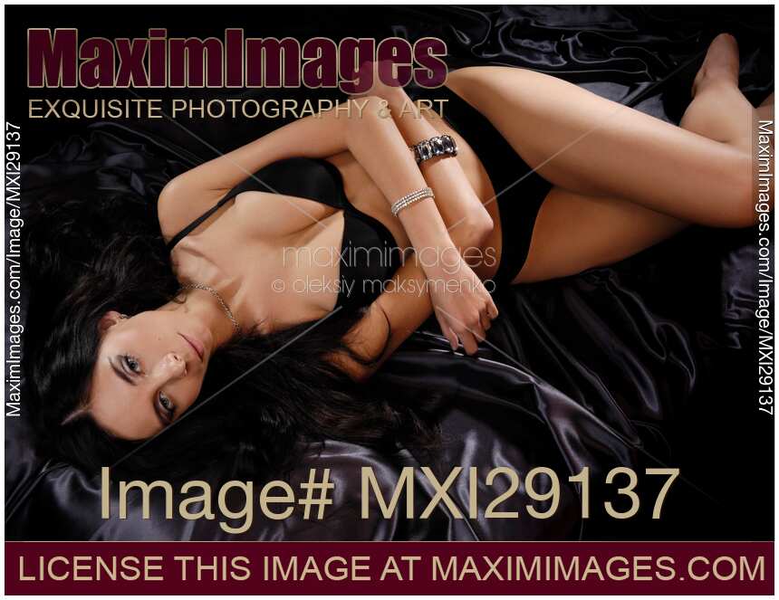 Beautiful Young Woman Lying on a Bed