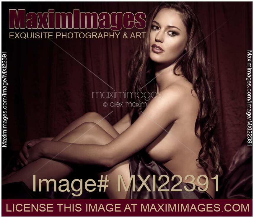 Beautiful Young Woman Sitting Naked in Bed