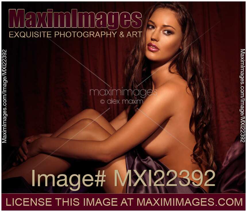 Beautiful Young Woman Sitting Naked in Bed