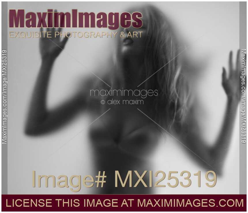 Beautiful young woman trapped behind glass