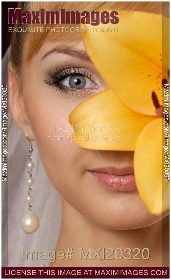 Beautiful Young Woman with a Yellow Lily
