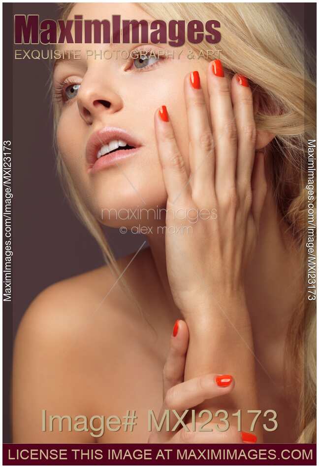 Beautiful Young Woman with Orange Nail Polish