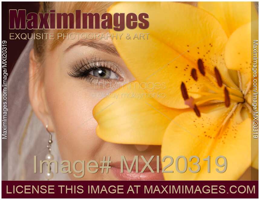 Beautiful Young Woman with Yellow Lily Closeup of Eyes