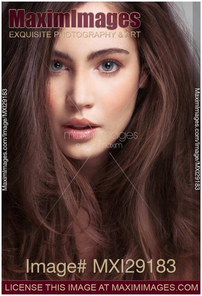 Beauty face portrait of a young woman with long brown hair and gray eyes