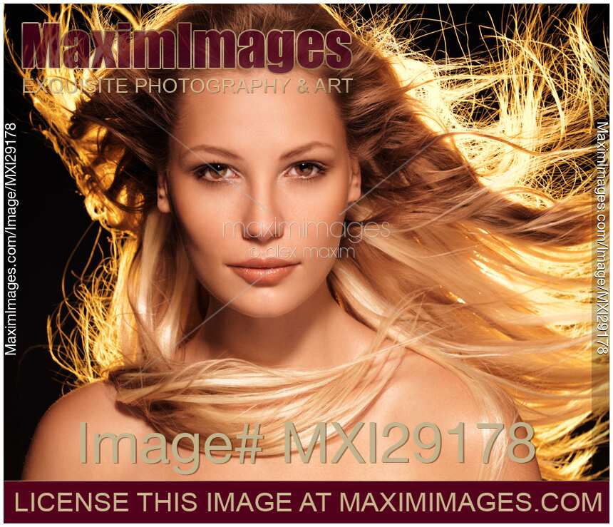 Beauty face portrait of woman with flying glowing blond hair
