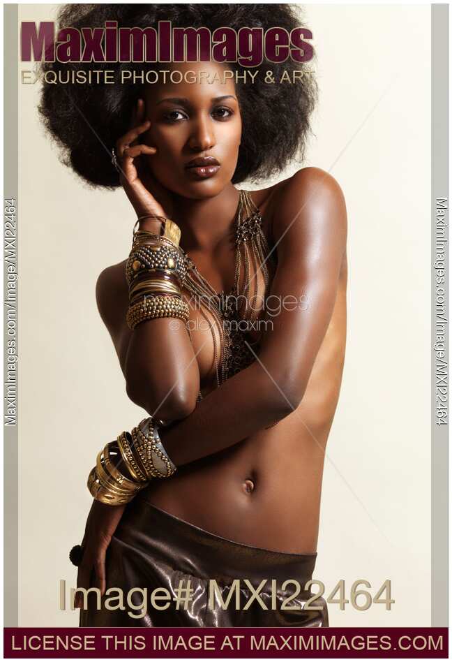 Beauty portrait of a black african american woman posing topless wearing jewelry