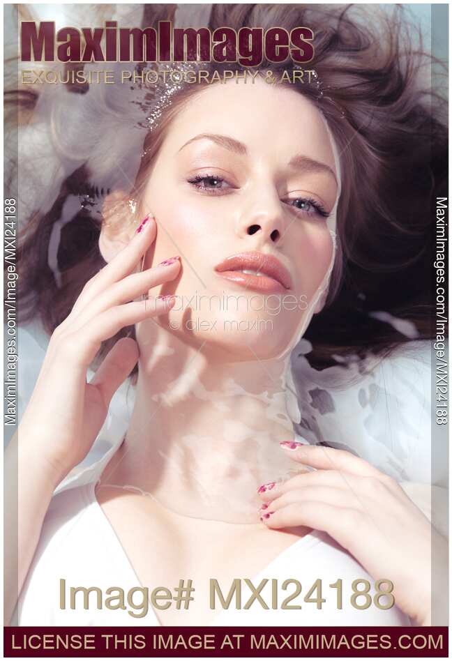 Beauty portrait of a woman lying in water