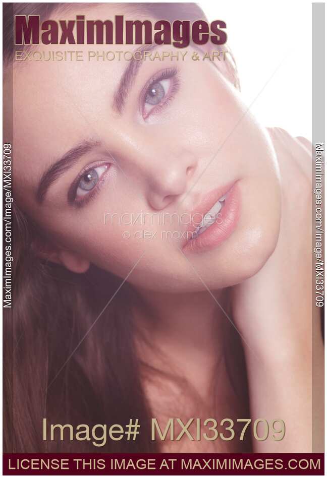 Beauty portrait of a woman with relaxed natural look, clean light skin and grey eyes