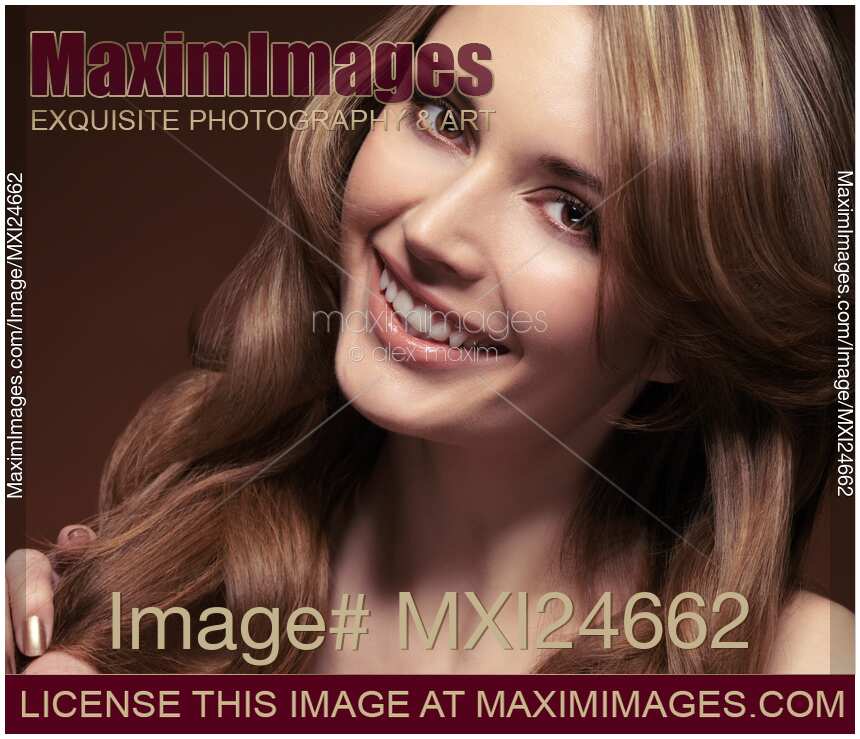 Beauty portrait of a young smiling woman with brown hair
