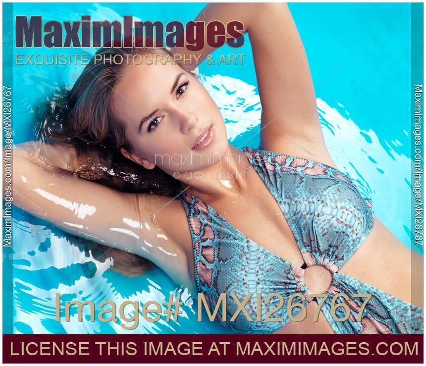 Beauty portrait of woman lying in blue water